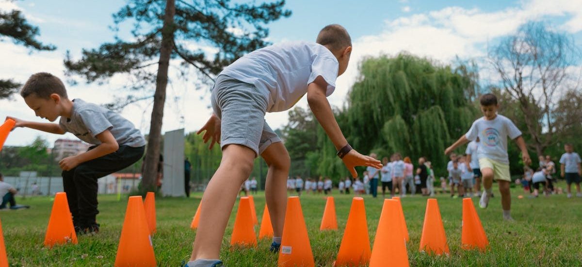 Group of kids enjoying exercise and play at a park obstacle course.