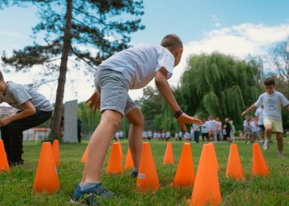 Group of kids enjoying exercise and play at a park obstacle course.